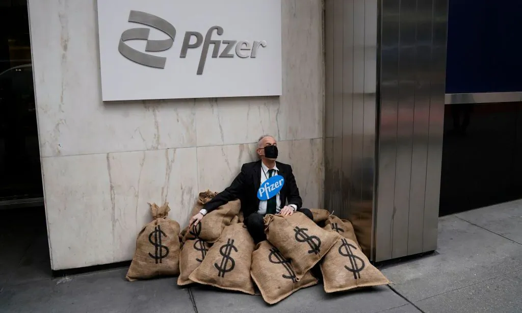 Center for Popular Democracy advocates stage a street theater simulated heist to call for equitable global access to COVID-19 vaccines and treatments outside Pfizer's New York headquarters, on April 25, 2022. (Timothy A. Clary/AFP via Getty Images)