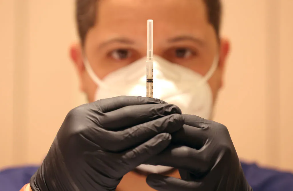 A man fills syringes with COVID-19 vaccine booster shots at a COVID-19 vaccination clinic in San Rafael, Calif., on April 6, 2022. (Justin Sullivan/Getty Images)