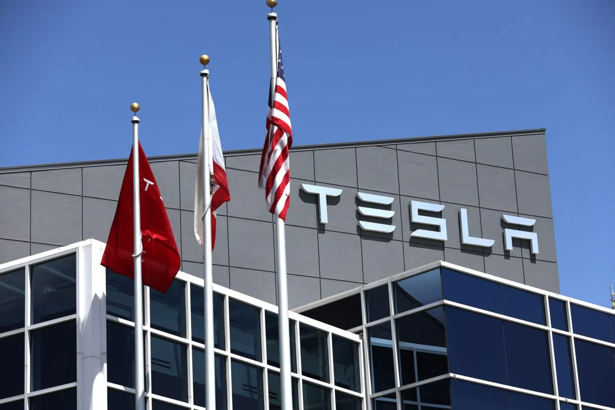 A sign is posted in front of a Tesla office in Fremont, Calif., on April 20, 2022. (Justin Sullivan/Getty Images)