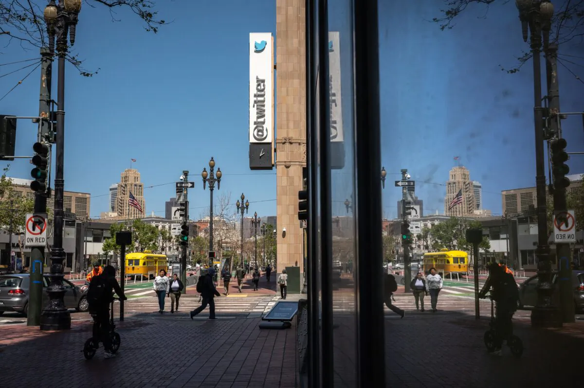 People walk past the Twitter headquarters in downtown San Francisco, on April 26, 2022. (Amy Osborne/AFP via Getty Images)
