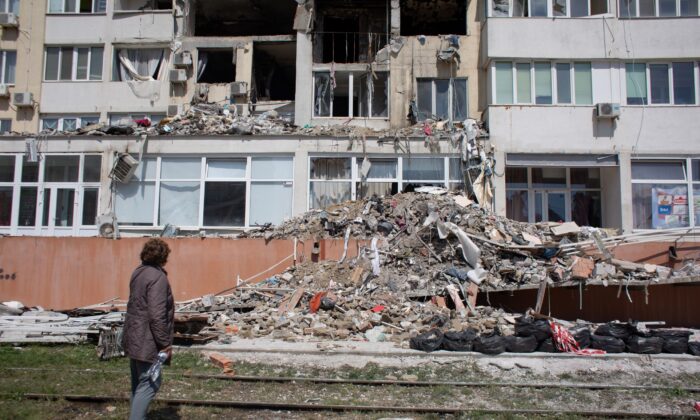 A resident whose apartment got destroyed as a result of a missile strike on a residential building, looks at the work of the rescue team in Odessa, Ukraine, on April 25, 2022. (Anastasia Vlasova/Getty Images)