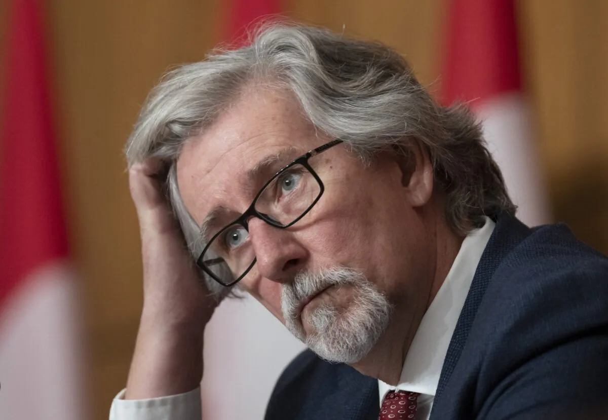 Privacy Commissioner of Canada Daniel Therrien listens to a question during a news conference, Dec. 9, 2021 in Ottawa. (The Canadian Press/Adrian Wyld)
