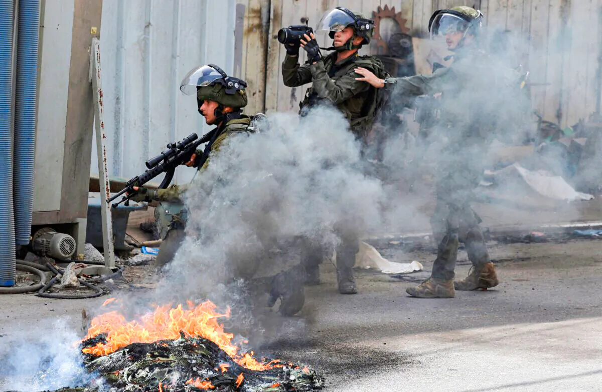 Israeli soldiers take positions during clashes with Palestinian in village of Azzun in the north of the occupied West Bank after the funeral of Yahya Adwan, who was killed during an overnight Israeli army operation, on April 30, 2022. (Jaafar Ashtiyeh/AFP via Getty Images)