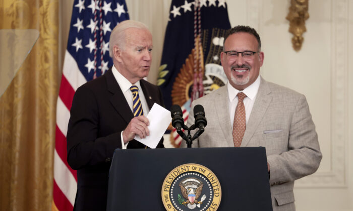 U.S. President Joe Biden and U.S. Education Secretary Miguel Cardona deliver remarks during an event for the 2022 National and State Teachers of the Year in the East Room of the White House on April 27, 2022 in Washington, DC. (Anna Moneymaker/Getty Images)