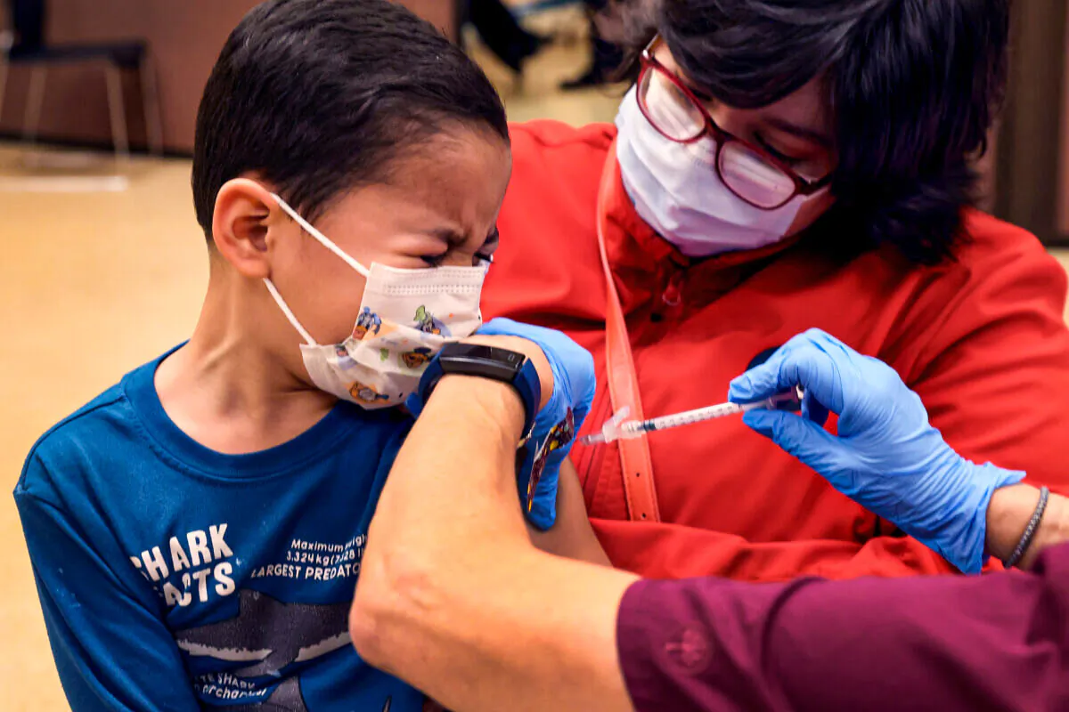 Leonel Campos, 6, receives a COVID-19 vaccine at Arturo Velasquez Institute in Chicago on Nov. 12, 2021. (Scott Olson/Getty Images)
