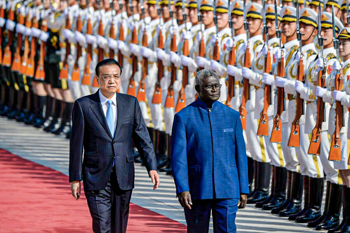 Solomon Islands Prime Minister Manasseh Sogavare and then-Chinese Premier Li Keqiang inspect honor guards during a welcome ceremony at the Great Hall of the People in Beijing on Oct. 9, 2019. (Wang Zhao/AFP via Getty Images)