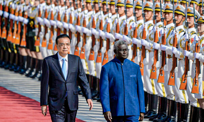 Chinese Premier Li Keqiang and Solomon Islands Prime Minister Manasseh Sogavare inspect honor guards during a welcome ceremony at the Great Hall of the People in Beijing, China, on Oct. 9, 2019. (Wang Zhao/AFP via Getty Images)