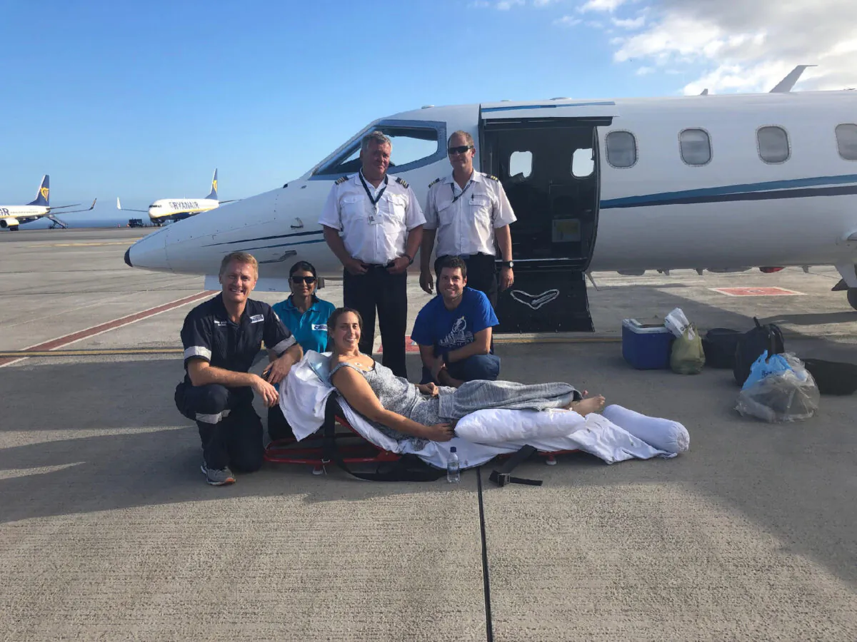 Kristen Yaldor poses with the crew that returned her to the United States after being attacked by a hippopotamus on the Zambezi River in Zimbabwe. (Photo courtesy of Ryan Yaldor)