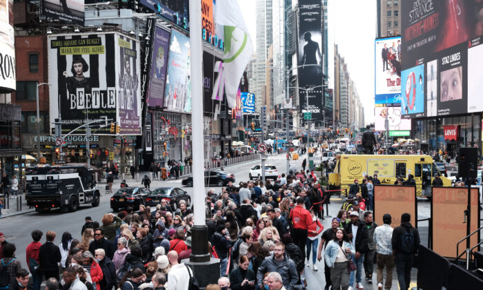 People wait in line to buy theater tickets in Times Square in New York City on April 27, 2022. Unlike other parts of Manhattan, Times Square is quickly returning to its pre-pandemic population with Broadway shows and area hotels at near full capacity on many nights. (Spencer Platt/Getty Images)