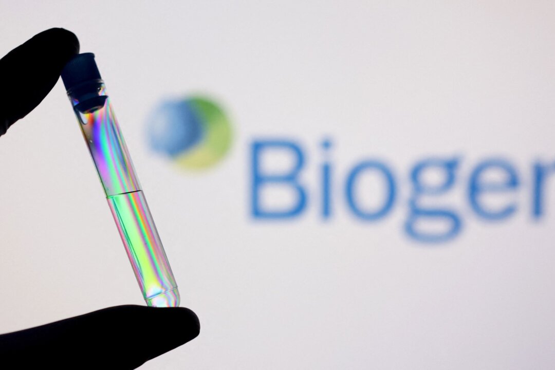 A test tube in front of displayed Biogen logo in this illustration taken on Dec. 1, 2021. (Dado Ruvic/Illustration/Reuters)