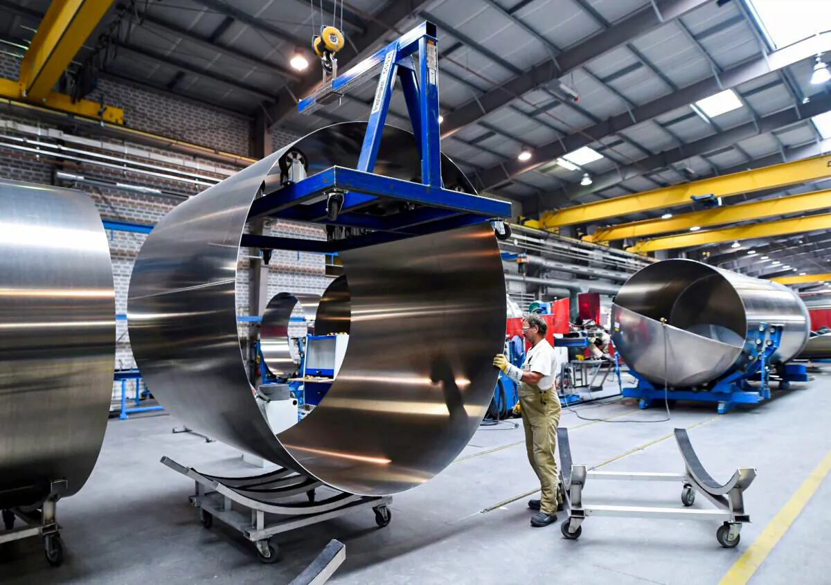A worker at German manufacturer of silos and liquid tankers, Feldbinder Special Vehicles, moves rolls of aluminium at the company's plant in Winsen, Germany, on July 10, 2018. (Fabian Bimmer/Reuters)