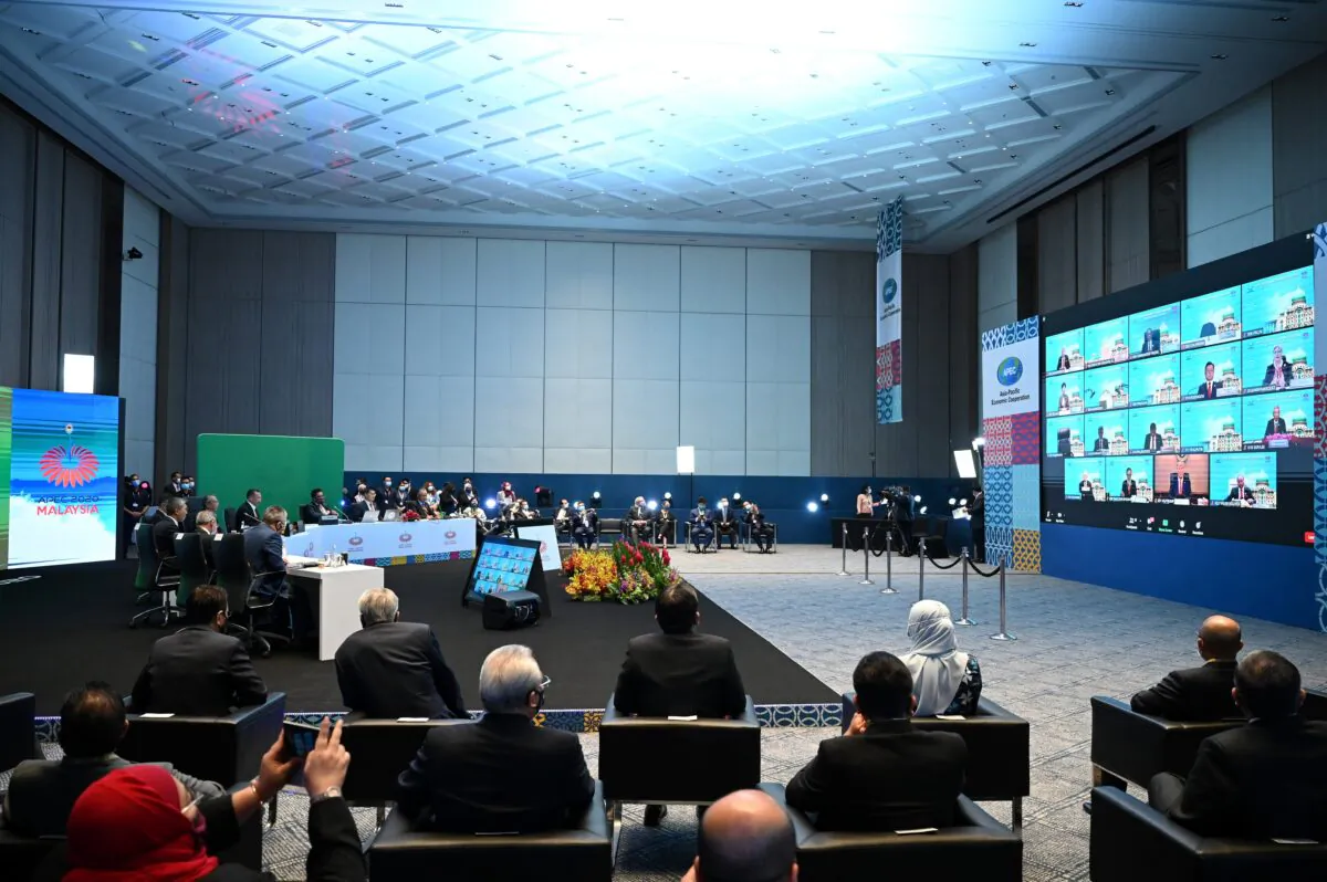 World leaders are pictured on a large screen (R) during the online Asia-Pacific Economic Cooperation (APEC) summit held in Kuala Lumpur, Malaysia, on Nov. 20, 2020. (Mohd Rasfan/AFP via Getty Images)