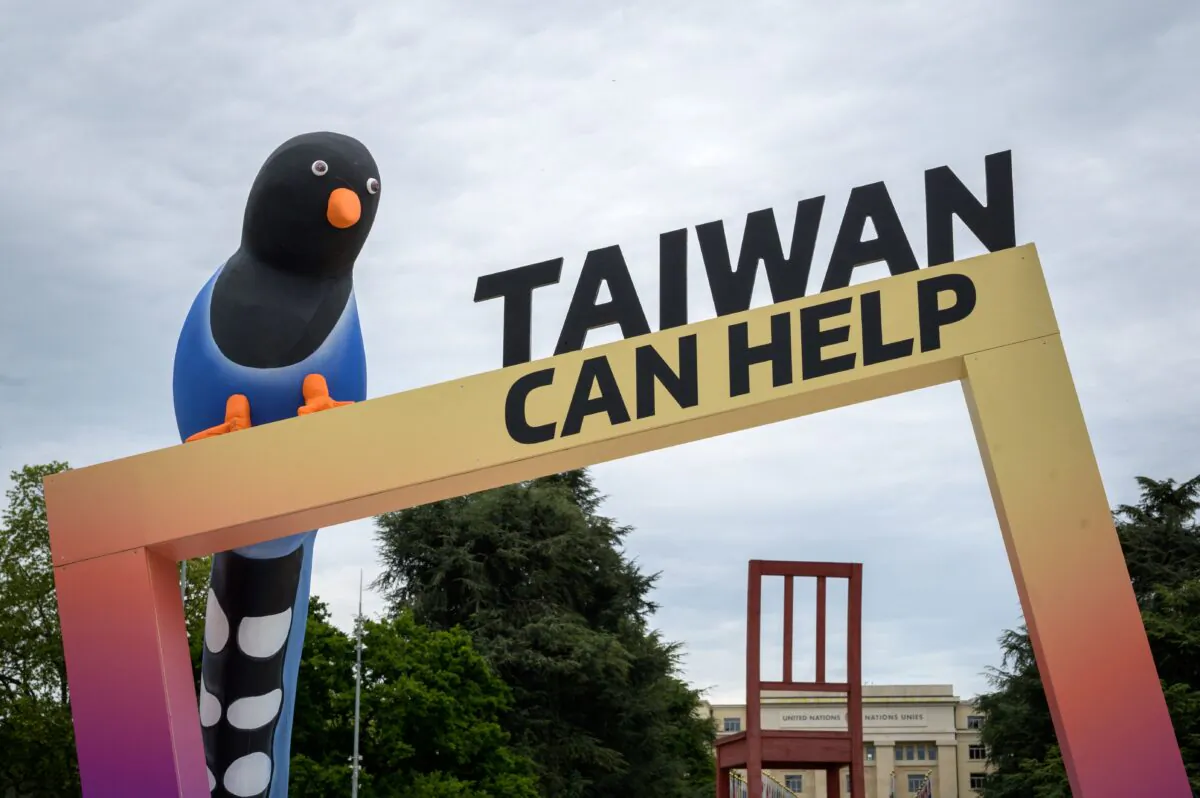 A sign promoting Taiwan's inclusion in the World Health Organization is seen next to the building of the United Nations Offices in Geneva on the opening day of the WHO's World Health Assembly on May 24, 2021. (Fabrice Coffrini/AFP via Getty Images)