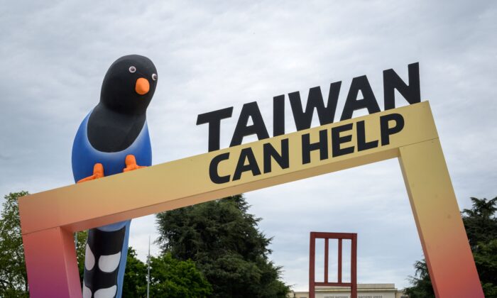 A sign promoting Taiwan's inclusion in the World Health Organization is seen next to the building of the United Nations Offices in Geneva on the opening day of the WHO's World Health Assembly on May 24, 2021. (Fabrice Coffrini/AFP via Getty Images)