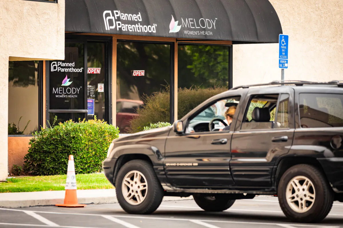 A woman waits in her car in front of a Planned Parenthood facility in Anaheim, Calif., on Sept. 10, 2020. (John Fredricks/The Epoch Times)