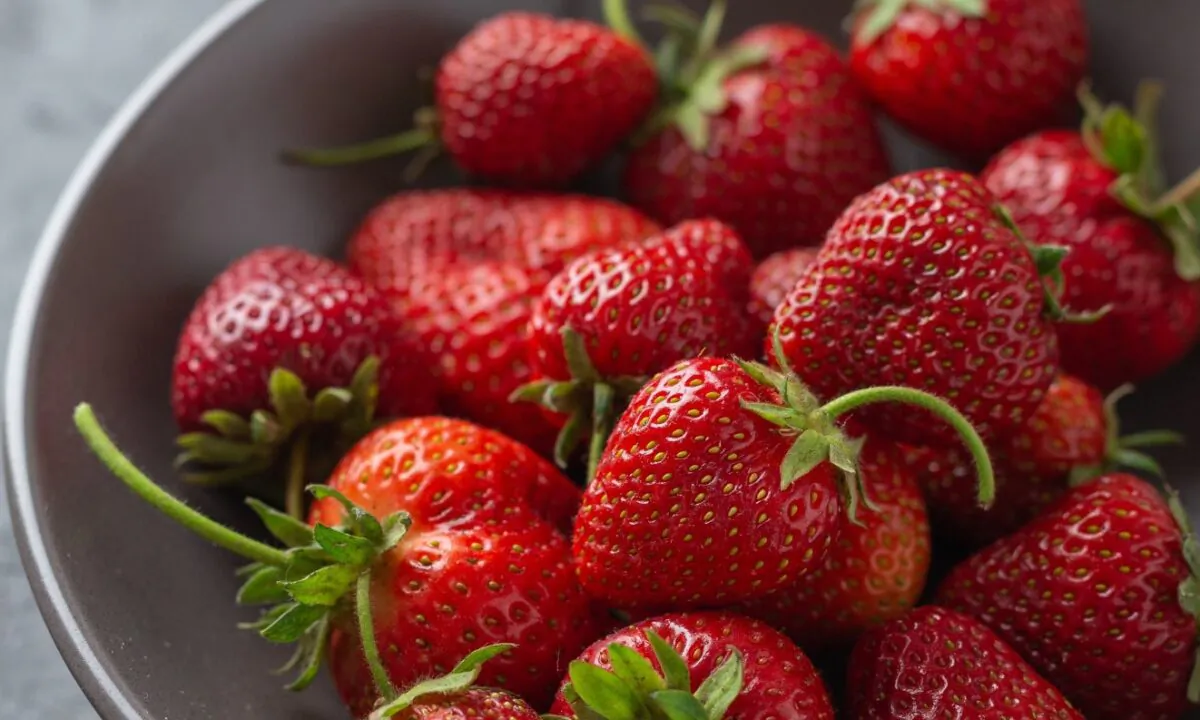 Look for firm fruits that are uniformly red from the tip of the berry to its fringed green stem, and have a sweet, rich aroma. (Jennifer McGruther)