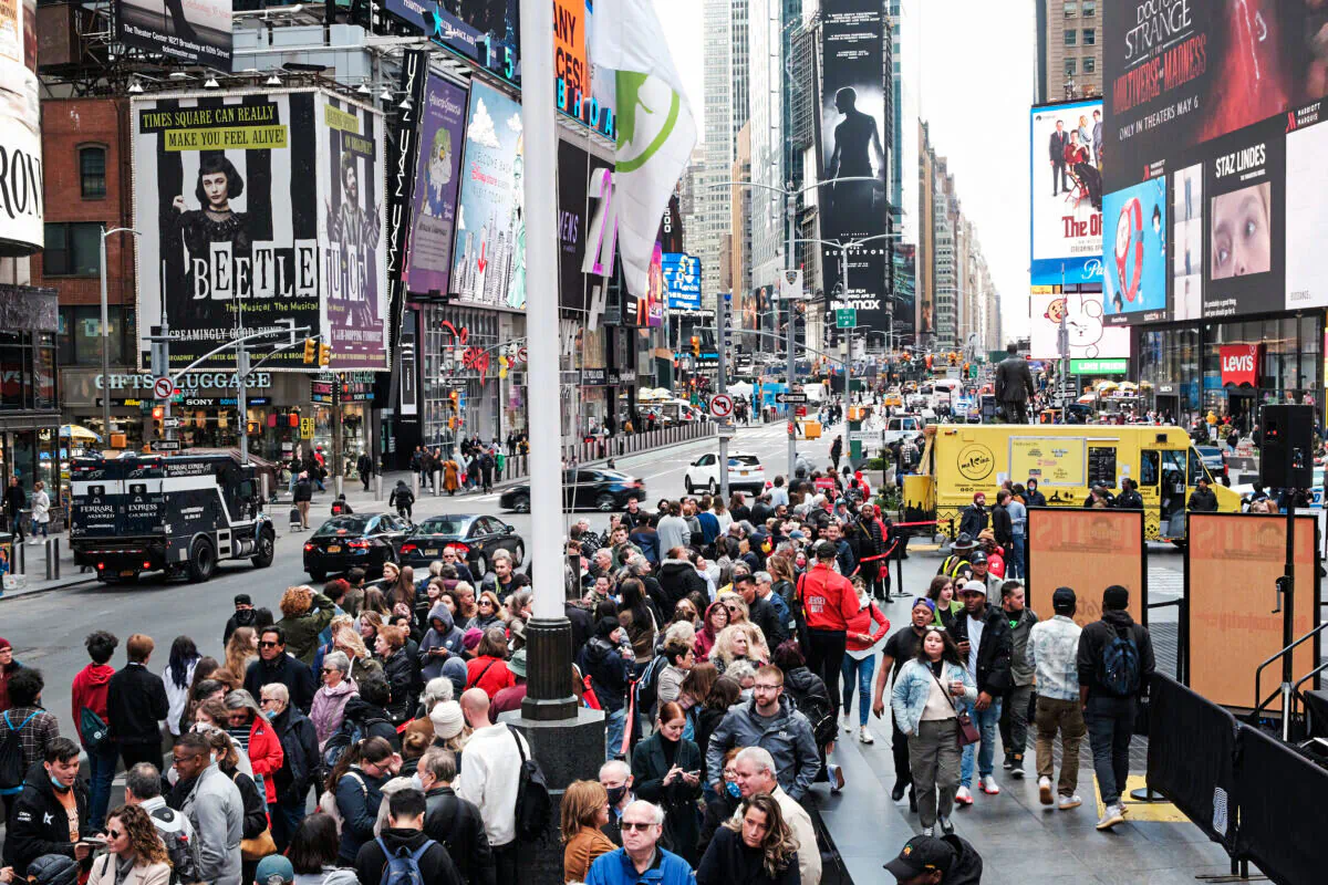 People wait in line to buy theater tickets in Times Square in New York City on April 27, 2022. Unlike other parts of Manhattan, Times Square is quickly returning to its pre-pandemic population with Broadway shows and area hotels at near full capacity on many nights. (Spencer Platt/Getty Images)
