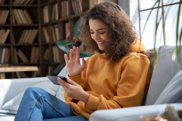 A woman using a communication app on her phone