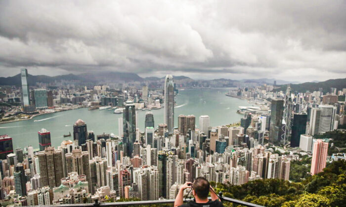 A visitor sets up his camera in the Victoria Peak area in Hong Kong to photograph Hong Kong's skyline, on Sept. 1, 2019. (Jae C. Hong/AP Photo)