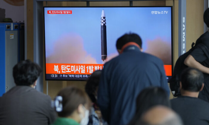 People watch a TV screen showing a news program reporting about North Korea's missile with file footage, at a train station in Seoul, South Korea, on May 4, 2022. (Lee Jin-man/AP Photo)