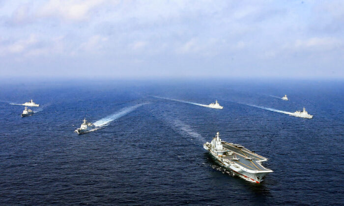 China's sole operational aircraft carrier, the Liaoning (front), sailing with other ships during a drill at sea in April 2018. (AFP via Getty Images)