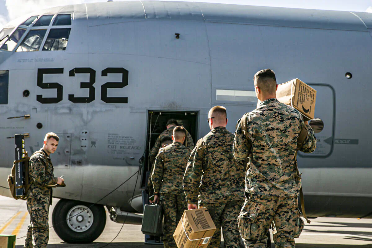 U.S. Marines and Sailors with Combat Logistics Regiment 3, 3d Marine Logistics Group, board a U.S. Air Force C-130 Hercules at Kadena Air Base, Japan, Dec. 6, 2021. (U.S. Marine Corps photo by Sgt. Hailey D. Clay)