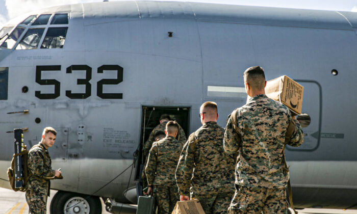 U.S. Marines and Sailors with Combat Logistics Regiment 3, 3d Marine Logistics Group, board a U.S. Air Force C-130 Hercules at Kadena Air Base, Japan, Dec. 6, 2021. (U.S. Marine Corps photo by Sgt. Hailey D. Clay)