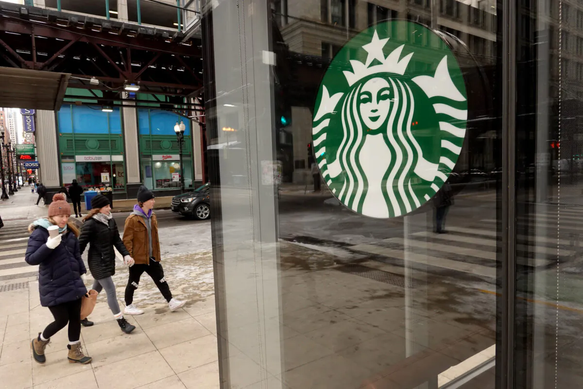 A Starbucks logo hangs in the window of one of the chain's coffee shops in the Loop in Chicago on Jan. 4, 2022. (Scott Olson/Getty Images)