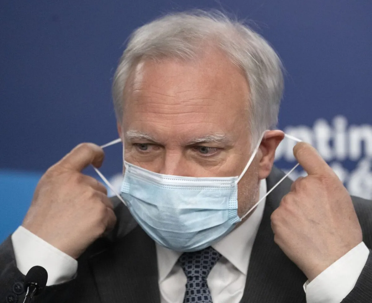 Quebec interim health director Dr. Luc Boileau removes his mask as he arrives to give a COVID-19 update, April 21, 2022, in Montreal. (The Canadian Press/Ryan Remiorz)