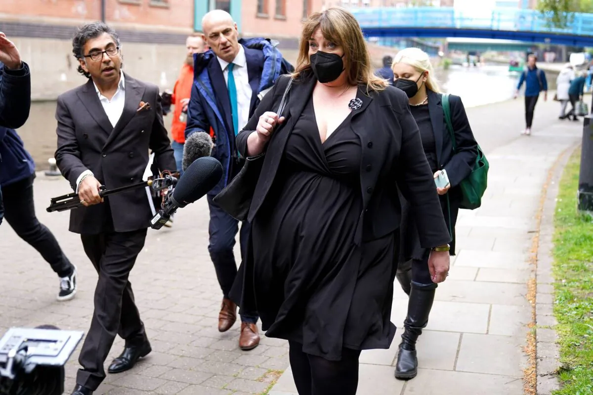 Caroline Henry, Nottinghamshire police and crime commissioner, is confronted by journalists outside Nottingham Crown Court in England on May 3, 2022. (PA Media)