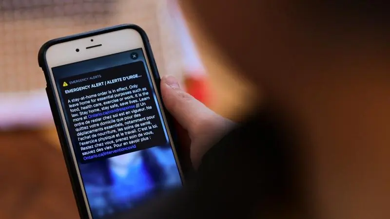 An emergency alert regarding a stay-at-home order during the COVID-19 pandemic is viewed on a mobile phone in Eastern Ontario, Canada, on Jan. 14, 2021. (Sean Kilpatric/The Canadian Press)