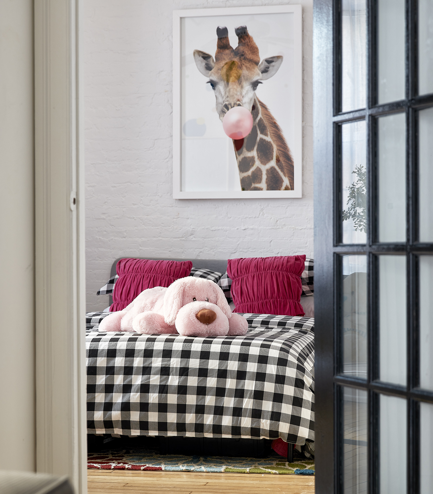 a children's bedroom with black and white gingham printed bedding