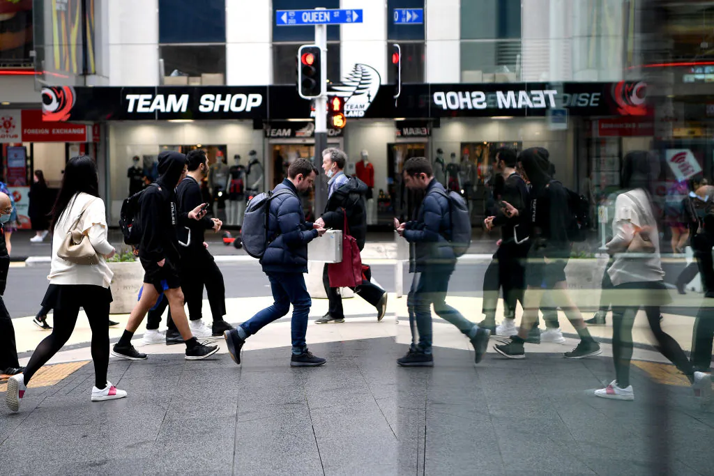 Pedestrians make their way down Queen Street in Auckland, New Zealand, on Sept. 24, 2020. (Hannah Peters/Getty Images)