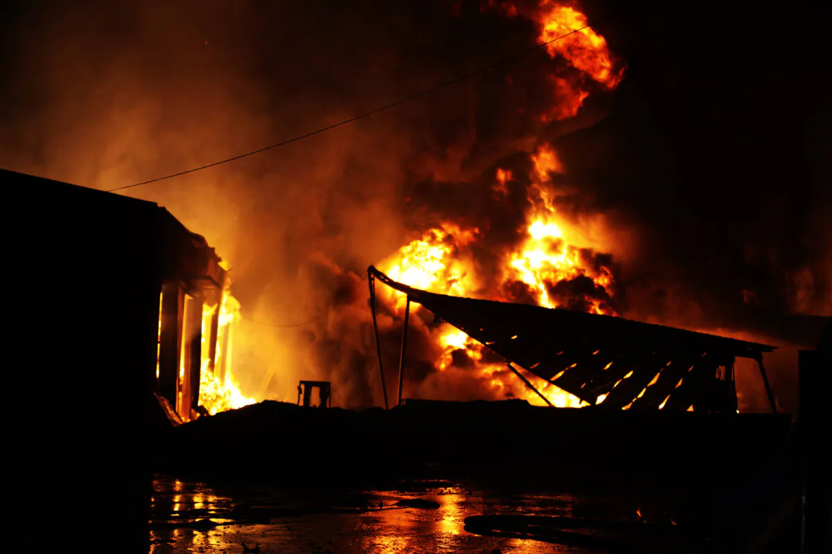 Fire and smoke from a warehouse blaze near Hongshiya Subdistrict of Huangdao District on August 16, 2015 in Qingdao, Shandong Province, China. (Getty Images)