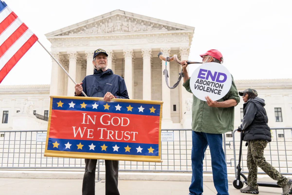 Activists protest in response to the leaked Supreme Court draft decision to overturn Roe v. Wade in front of the U.S. Supreme Court in Washington on May 3, 2022. (Louis Chen/The Epoch Times)