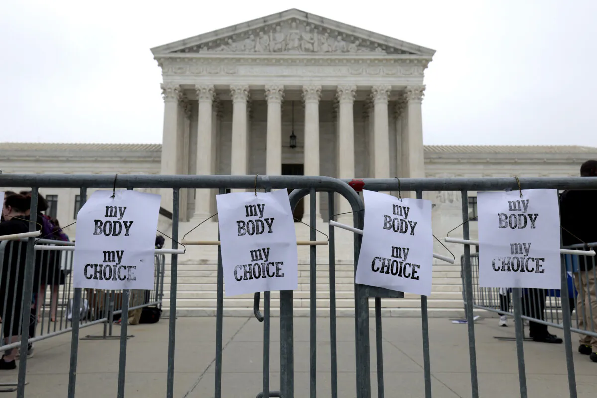 Pro-abortion signs hang on a police barricade at the U.S. Supreme Court Building in Washington on May 3, 2022. (Anna Moneymaker/Getty Images)