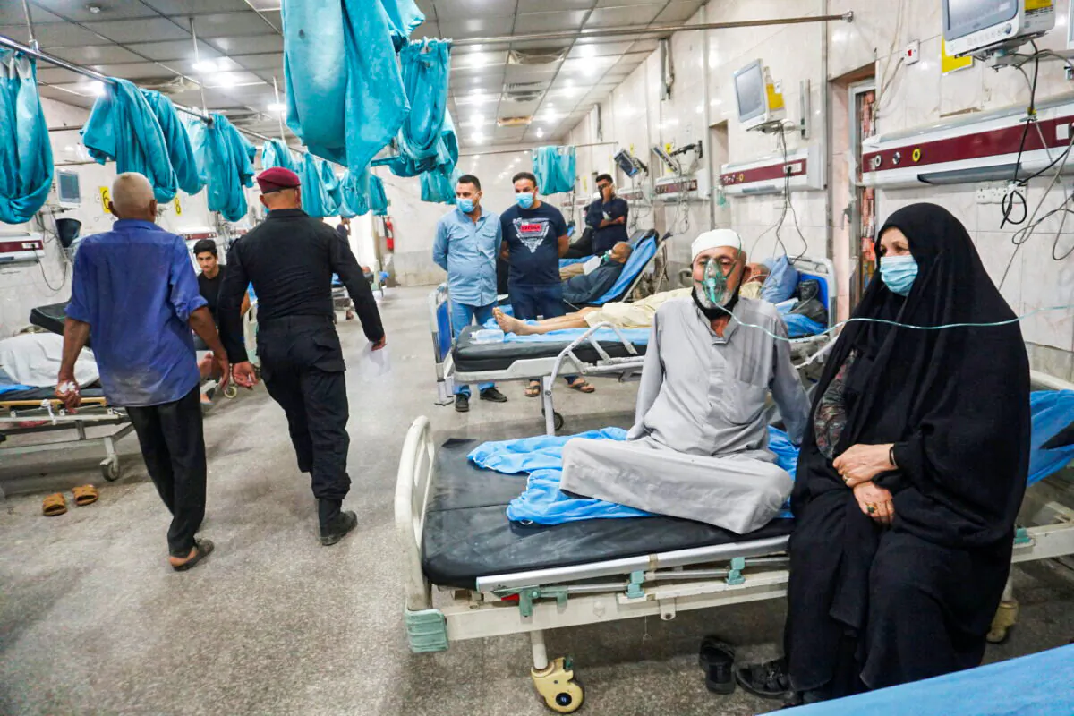 Iraqi people receive oxygen support at a hospital during a sandstorm in Baghdad, Iraq, on May 5, 2022. (Alaa Al-Marjani/Reuters)