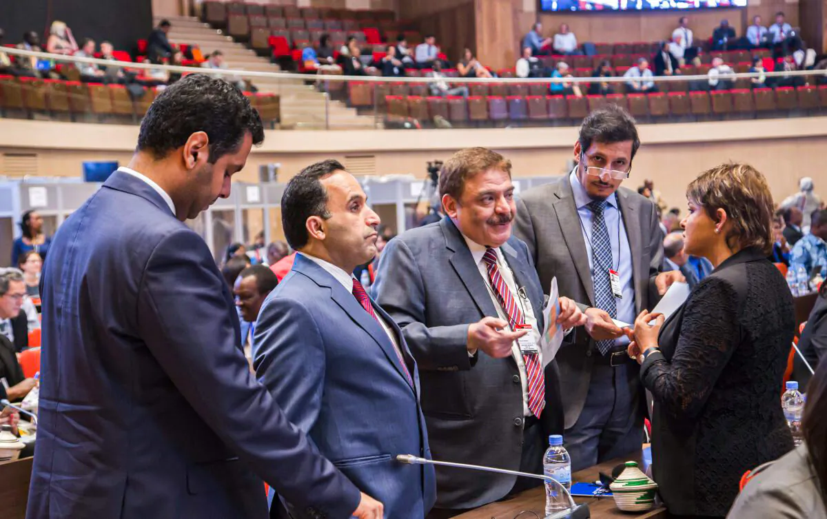 A group of unidentified delegates have a discussion during a break at the official opening of the 28th Meeting of the Parties to the Montreal Protocol on Substances that Deplete the Ozone Layer in Kigali, Rwanda, on Oct. 13, 2016. (AP Photo)