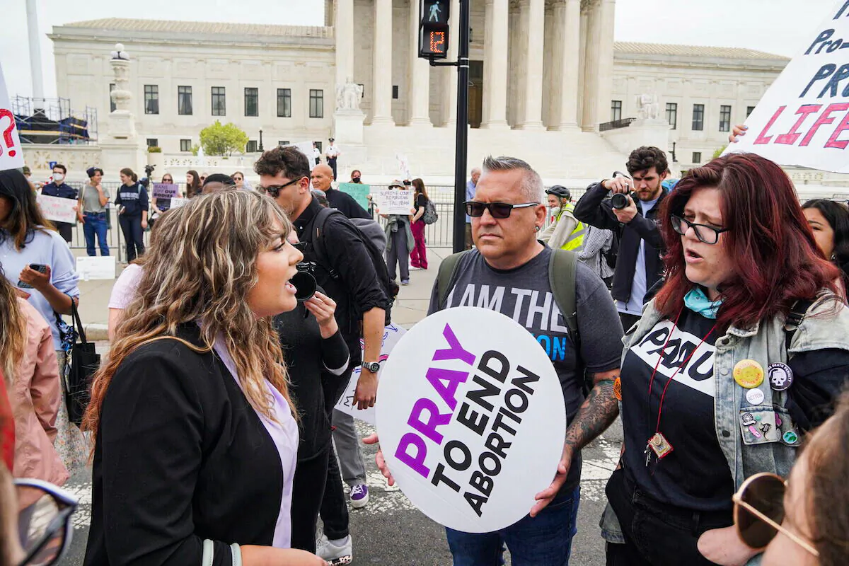 A pro-abortion protestor shouts at pro-life protestor Bryan Kemper (center) before the U.S. Supreme Court in Washington, D.C., on May 4, 2022. (Jackson Elliott/The Epoch Times)