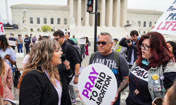 A pro-abortion protestor shouts at pro-life protestor Bryan Kemper (center) before the U.S. Supreme Court in Washington, D.C., on May 4, 2022. (Jackson Elliott/The Epoch Times)