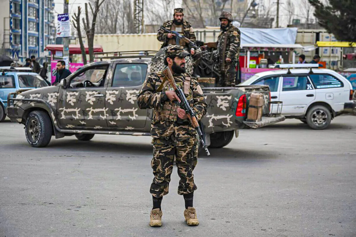 Taliban extremists stand guard along a street in Kabul on Jan. 21, 2022. (Mohd Rasfan/AFP via Getty Images)