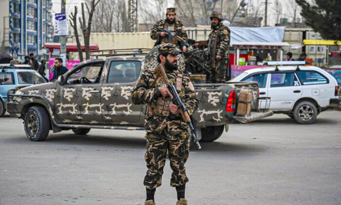 Taliban extremists stand guard during a demonstration by people to condemn a protest by the Afghan women's rights activists, in Kabul, on Jan. 21, 2022. (Mohd Rasfan/AFP via Getty Images)
