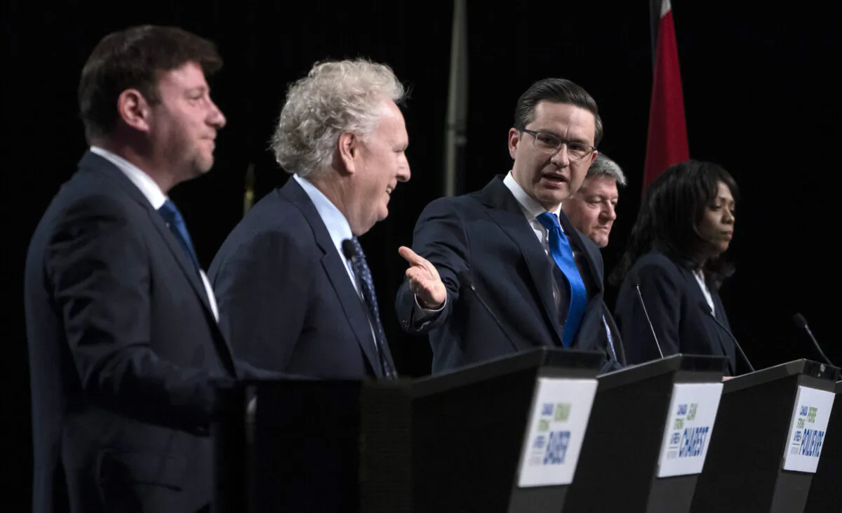 Conservative leadership candidate Pierre Poilievre gestures towards Jean Charest as Roman Baber, left, Scott Aitchison and Leslyn Lewis, right, debate at the Canada Strong and Free Network conference, in Ottawa on May 5, 2022. (Adrian Wyld/The Canadian Press)