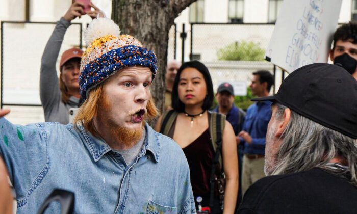 Pro-abortion protester Joseph Price screams at pro-life protestor Joe Green outside the Supreme Court on May 5, 2022. (Jackson Elliott/The Epoch Times)