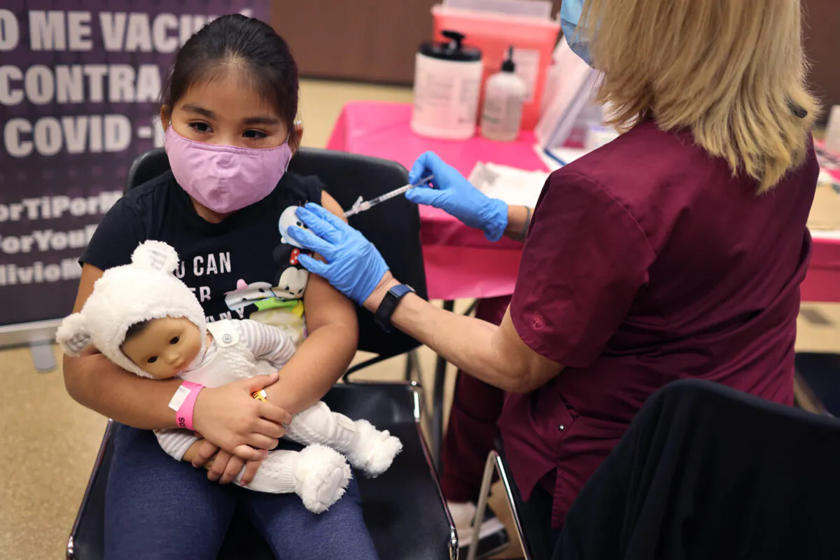 First grade student, seven-year-old Rihanna Chihuaque, receives a covid-19 vaccine at Arturo Velasquez Institute on November 12, 2021 in Chicago, Illinois. (Scott Olson/Getty Images)