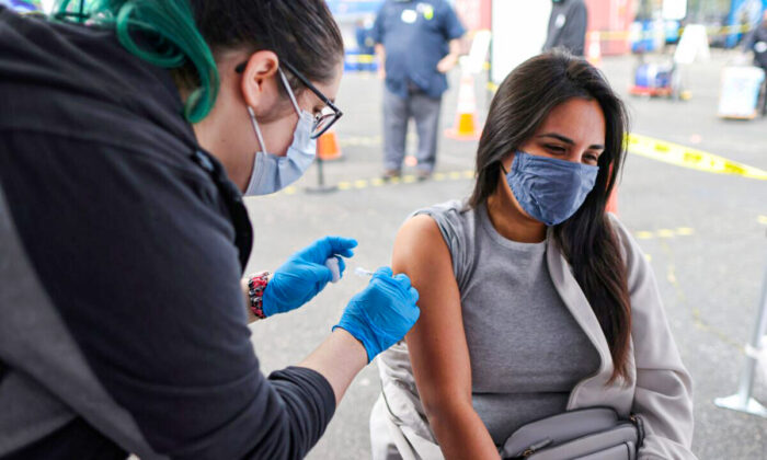 A woman receives a COVID-19 vaccine in Los Angeles, Calif., on March 25, 2021. (Lucy Nicholson/Reuters)