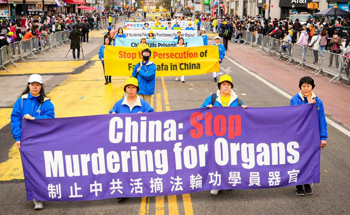 Falun Gong practitioners participate in a parade to commemorate the 23rd anniversary of the April 25th peaceful appeal of 10,000 Falun Gong practitioners in Beijing, in Flushing, N.Y., on April 23, 2022. (Larry Dye/The Epoch Times)