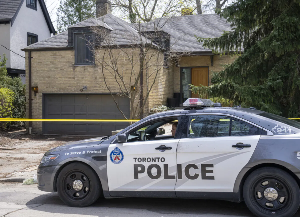 A police car is parked in front of the Rosedale house where the body of a young girl was found in a construction-site dumpster bin, in Toronto on May 5, 2022. (The Canadian Press/Frank Gunn)