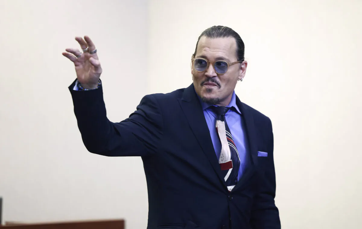 Actor Johnny Depp waves as he leaves the courtroom for a recess at the Fairfax County Circuit Court in Fairfax, Va., May 5, 2022. (Jim Lo Scalzo/Pool Photo via AP)