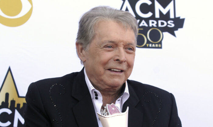 Mickey Gilley poses with the Triple Crown Award on the red carpet at the 50th annual Academy of Country Music Awards at AT&T Stadium in Arlington, Texas, on April 19, 2015. (Jack Plunkett/Invision/AP)